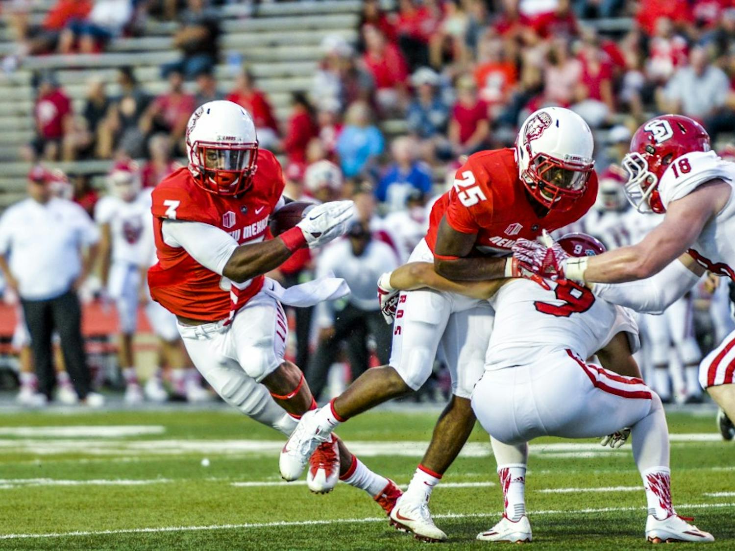 Junior running back Richard McQuarley, 3, finds a line through South Dakota's defense Thursday September 1, 2016 at University Stadium. The Lobos set the pace for their 2016 season with a 48-21 win over the Coyotes in their season opener. 