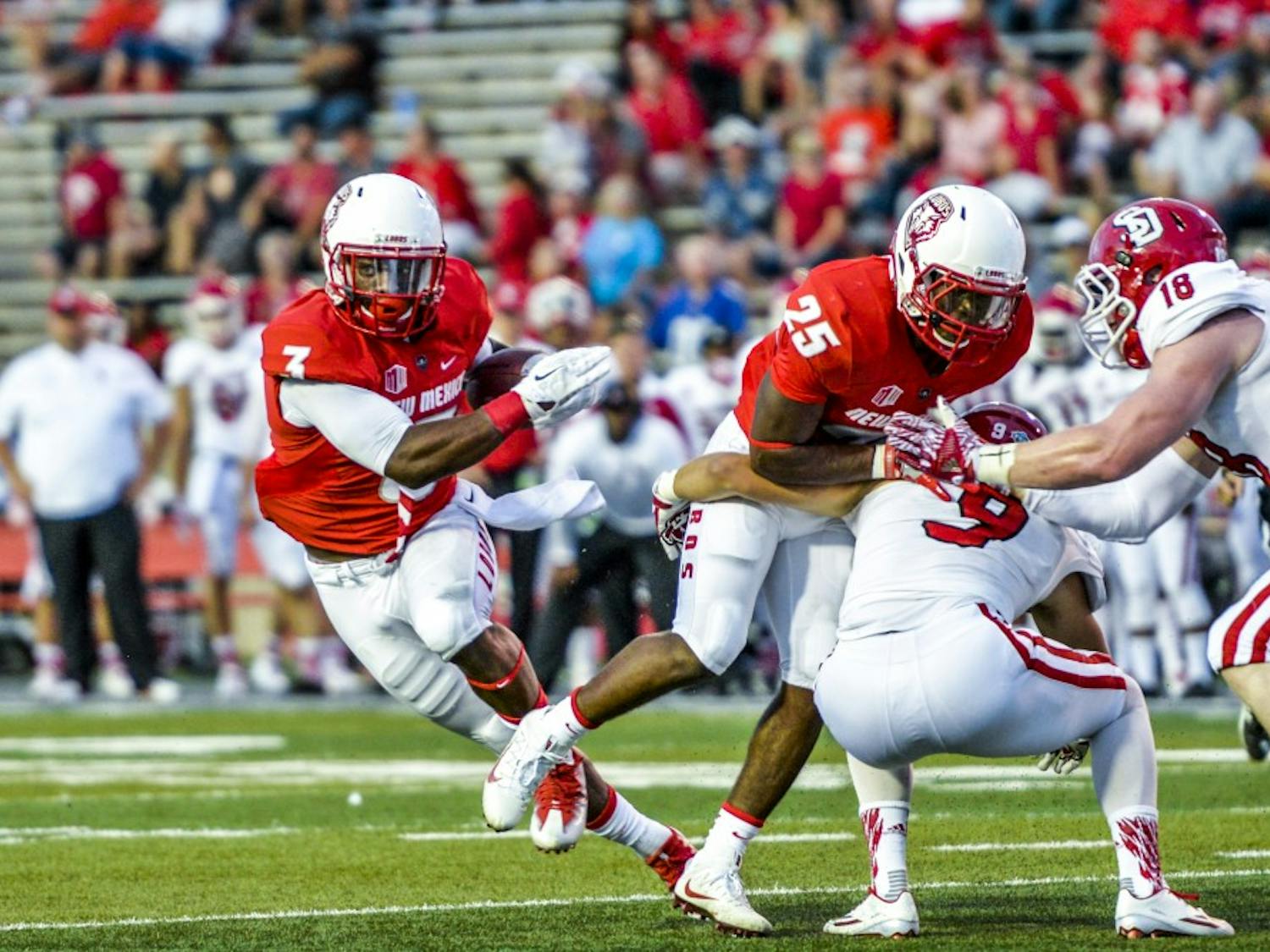 Junior running back Richard McQuarley, 3, finds a line through South Dakota's defense Thursday September 1, 2016 at University Stadium. The Lobos set the pace for their 2016 season with a 48-21 win over the Coyotes in their season opener.&nbsp;