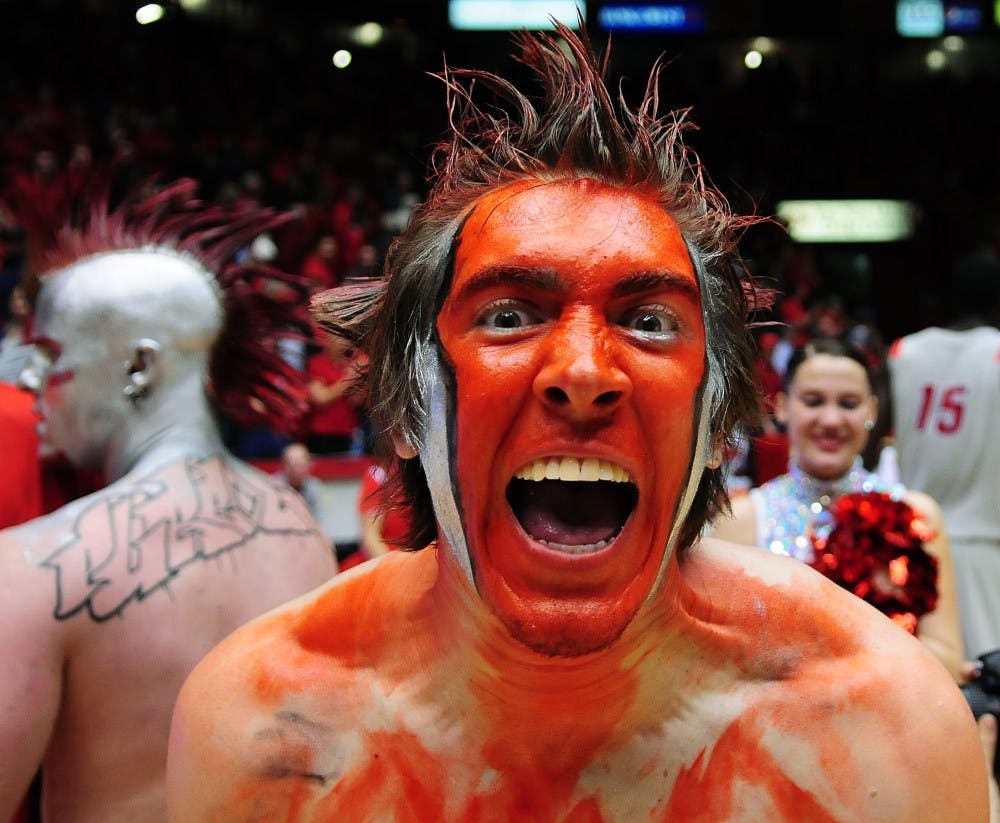 	A decorated fan rushes the court Thursday night. The Lobos snagged a narrow victory against No. 12 BYU, 76-72.