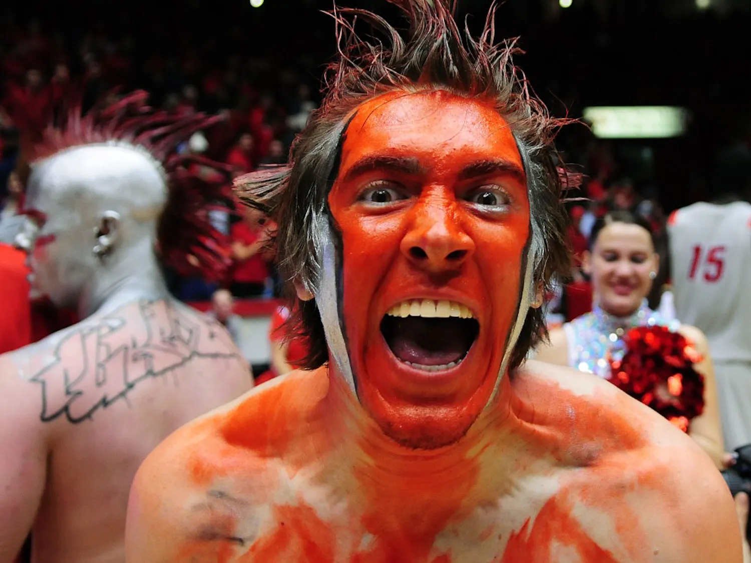 A decorated fan rushes the court Thursday night. The Lobos snagged a narrow victory against No. 12 BYU, 76-72.