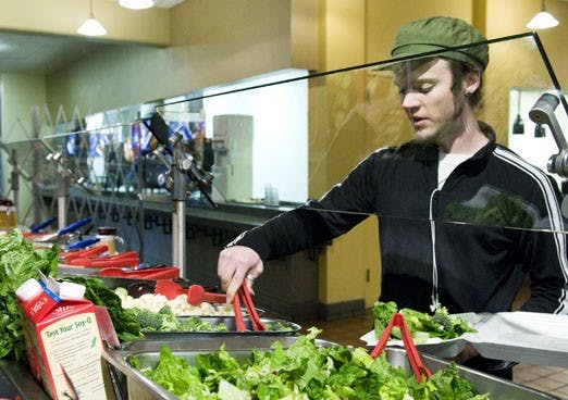 Student Martin McGregor prepares a salad at La Posada on Feb. 24, 2008. The UNM chapter of the Fair Trade Initiative is asking Chartwells to include more local produce in their food selections.