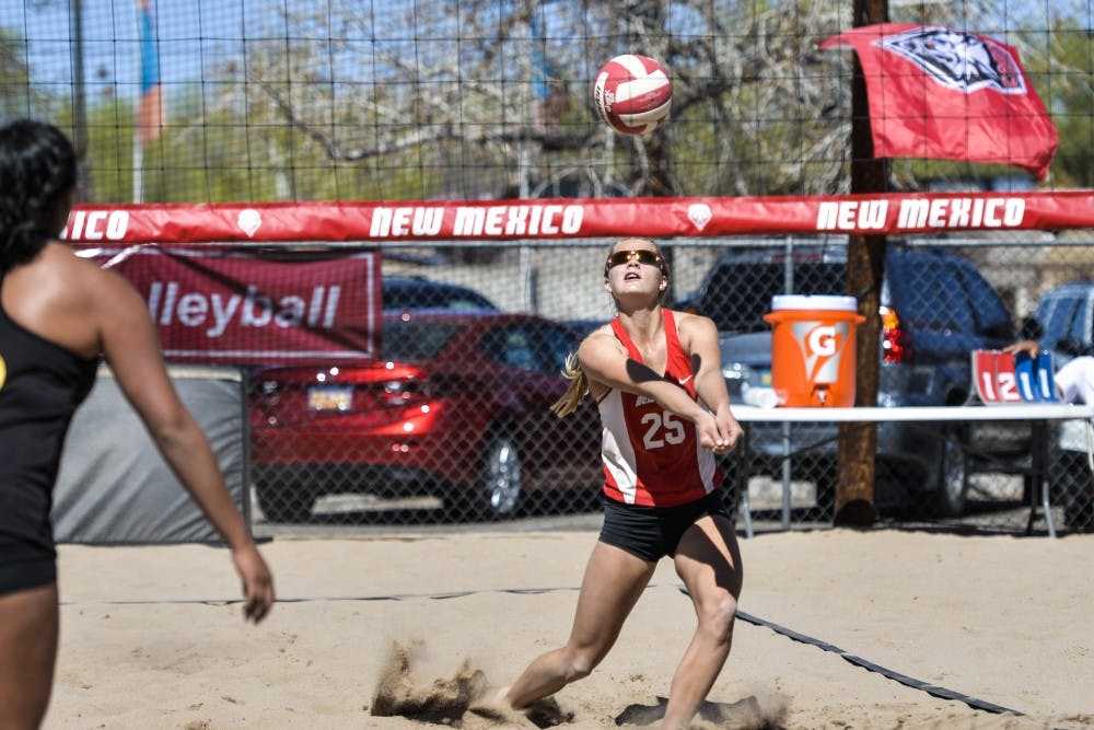 Junior Lise Rugland rushes to hit the ball back to set Devanne Sours up for a kill against a Colorado Mesa player March 18, 2016 at Lucky 66 Bowls sand volleyball courts. The Lobos beach volleyball program was ranked in the top 20 programs in the nation by DiG magazine.