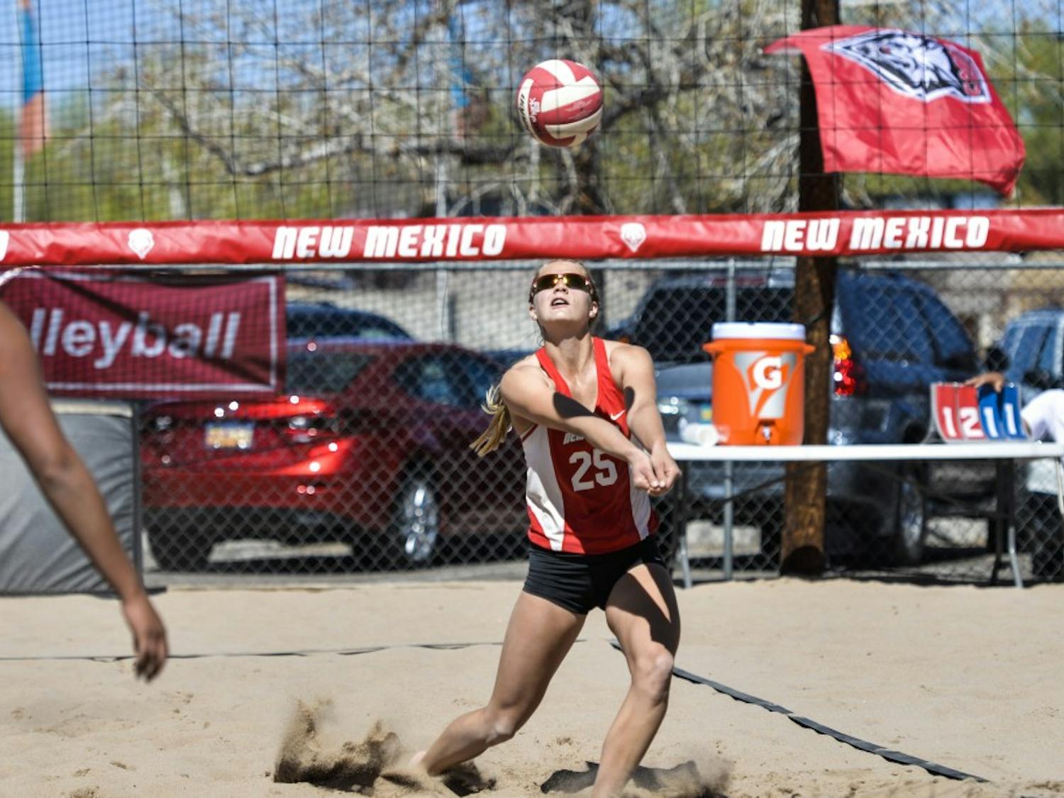 Junior Lise Rugland rushes to hit the ball back to set Devanne Sours up for a kill against a Colorado Mesa player March 18, 2016 at Lucky 66 Bowls sand volleyball courts. The Lobos beach volleyball program was ranked in the top 20 programs in the nation by DiG magazine.