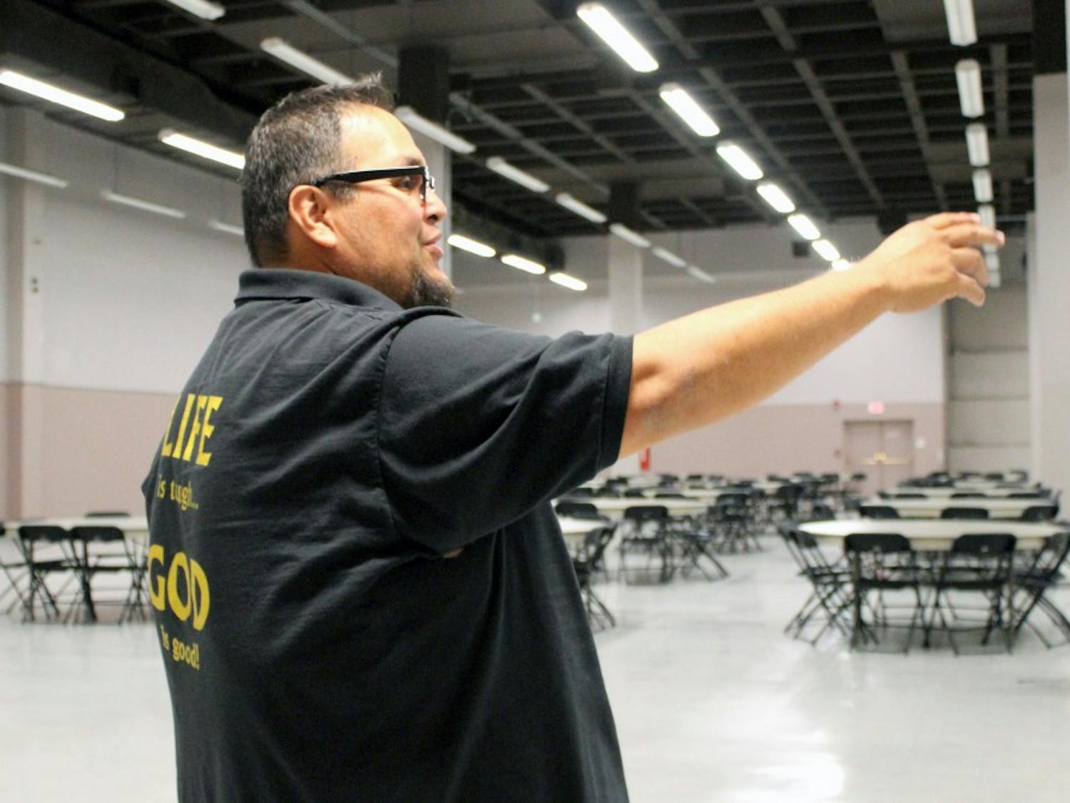 Dennis Billy, residence service manager at Joy Junction, discusses the setup for Thursday’s Thanksgiving meal on Tuesday afternoon. Joy Junction will serve 1,500 families at the convention center.