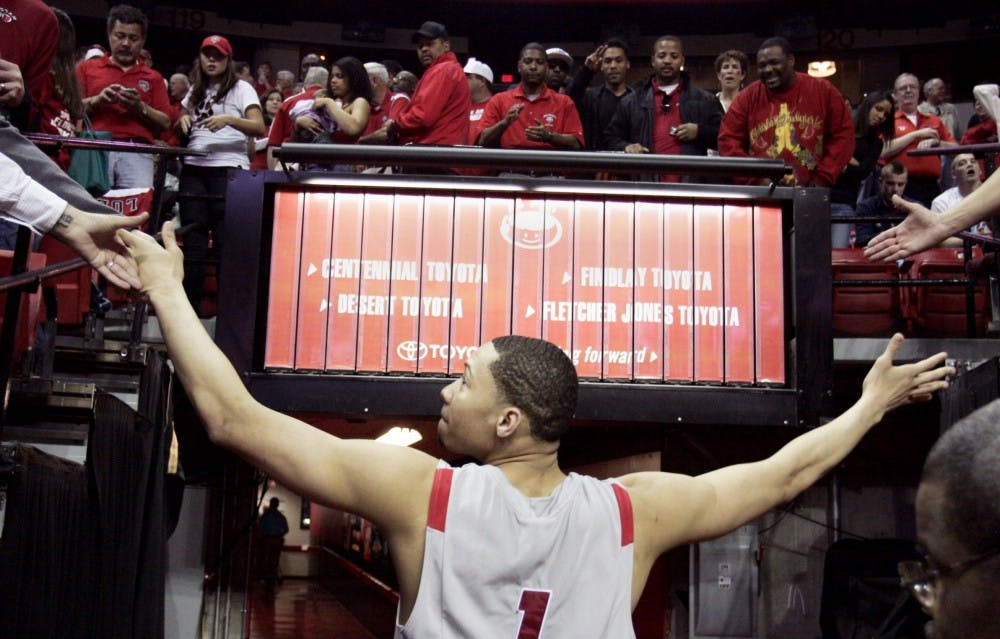 	Below: Fans congratulate Lobo swingman Darington Hobson while he walks toward the locker room at the Thomas &amp; Mack Center on Thursday. The Lobos beat No. 9 Air Force 75-69. Hobson had 28 points and 15 rebounds.