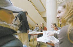 Ashley Moyer, left, and Marisol Enyart talk during a Pastors for Peace meeting in Dane Smith Hall on Saturday. Pastors for Peace is traveling across the United States collecting donations for humanity efforts in Cuba.