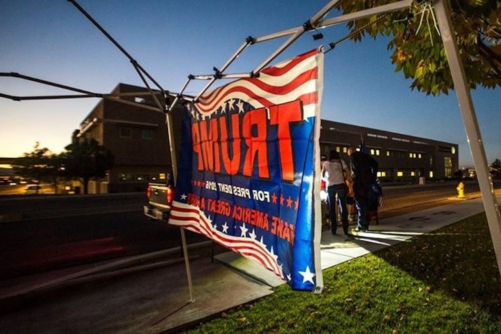 A Donald Trump flag hangs at a merchandise tent outside of a rally held by Republican vice presidential candidate Mike Pence on Thursday, Oct. 20, 2016 in Albuquerque, New Mexico. Hundreds gathered at Embassy Suites Hotel in support of Pence and Trump.&nbsp;