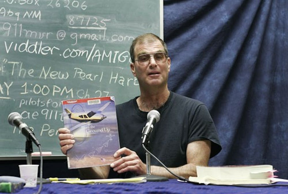 Simon Polakowski holds "From the Ground Up" during a recording of "9/11 Myth vs. Reality" in the studio Monday.