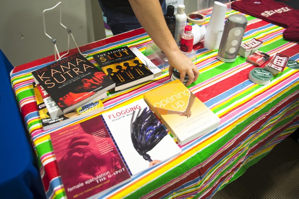 Books dealing with various topics on sex lay on a table during a UNM Sex Week event.