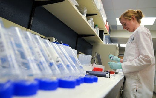 Melynda Byers processes DNA as part of a study at the Mind Research Network's new neurogenetics lab. 