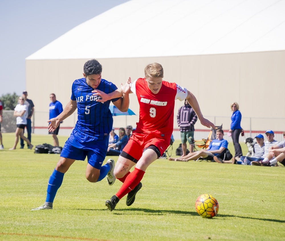 Foward Luke Lawrence (9) battles for possession the ball the fie