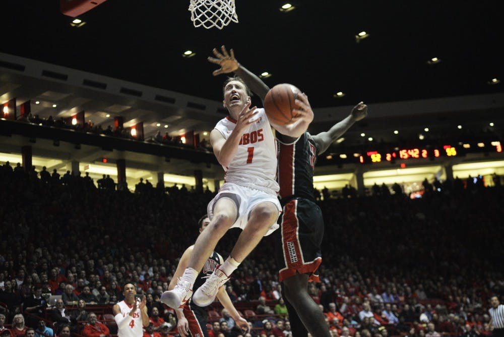 Redshirt sophomore guard Cullen Neal jumps in the air for a lay up while being guarded by a UNLV player Tuesday, Feb. 2, 2016 at WisePies Arena. The Lobos lost to San Diego State University 78-71. 