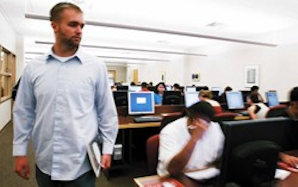 Former UNM student Mitch Hastings walks through the Lobo Lab in the basement of the SUB on Wednesday. He is the creator of irecess.com, a Web site where high school and college students can share information about classes.