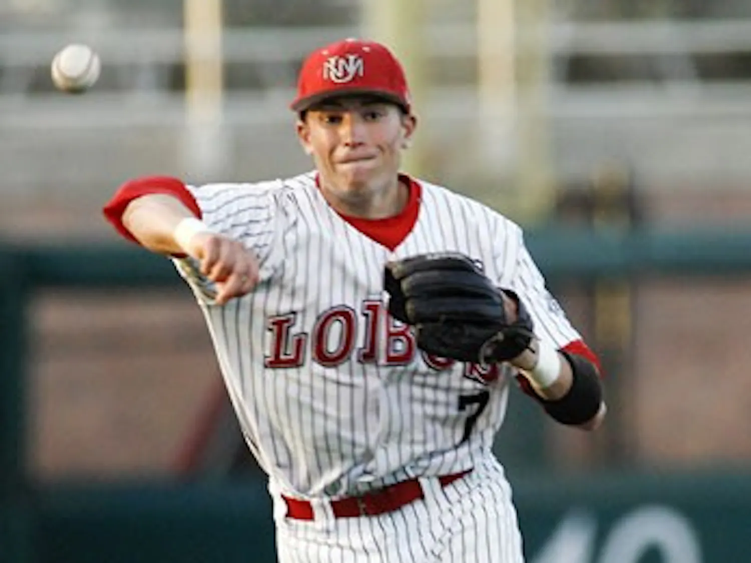 Shortstop Scott Gracey throws in Tuesday's game against NMSU at Isotopes Park. The Lobos lost Tuesday's game 15-2 but bounced back and defeated NMSU 13-1 on Wednesday.