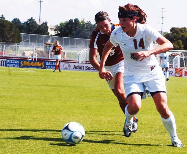 UNM's Alexis Ball dribbles away from Longhorns' Kendall Campise during an exhibition match at the UNM Soccer Complex on Friday. The Lobos tied 0-0.