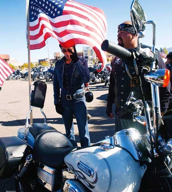 Amy Barreres and Angelo Lopez wait by their motorcycle before leaving The Pit on Sunday after a rally for patriotism and the American flag. 
