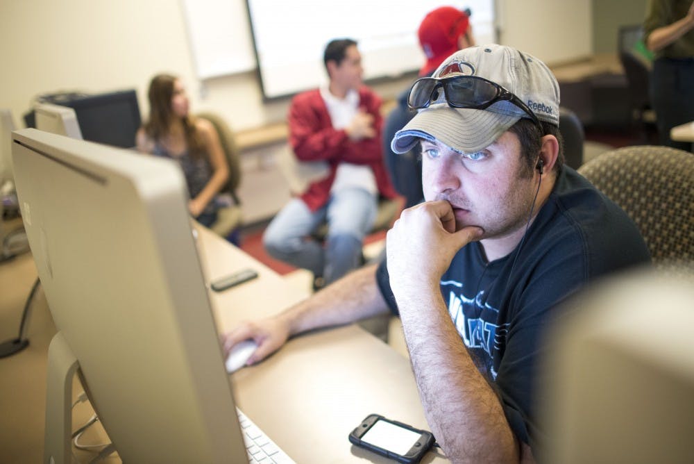 Kenneth Ferguson, a  junior in journalism and mass communication, works with the Follow Up Question team for the CD1 Twitter town hall debate between Democratic Rep. Michelle Lujan Grisham and Republican congressional hopeful Mike Frese that was hosted by the New Mexico News Port on Thursday. The candidates were tweeted questions and were given three tweets to respond, getting a chance for rebuttal tweets in response to their opponent’s answers.