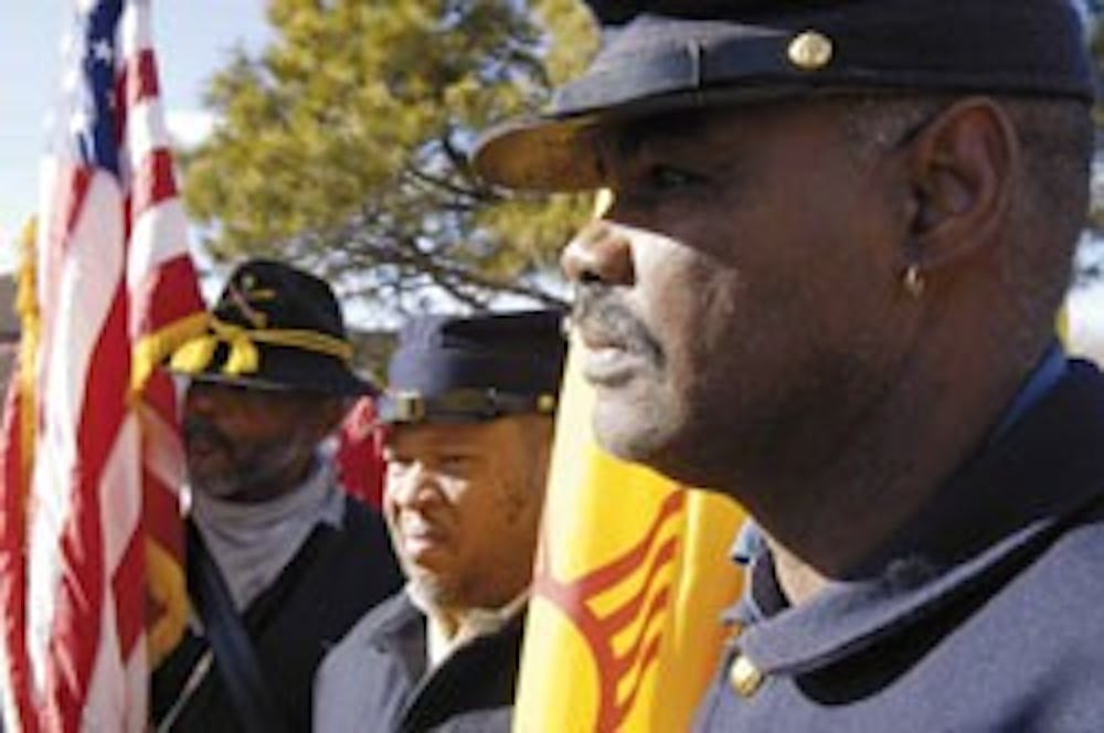 Buffalo Soldiers Society of New Mexico members from right, Charles Summerset, Harold Pope and Van Sanders wait before the beginning of a parade in remembrance of Martin Luther King Jr. on Sunday on Redondo Drive. 