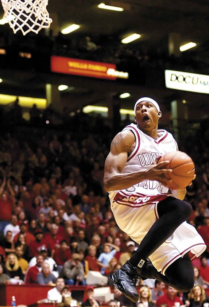 Lobo guard J.R. Giddens goes up for a reverse dunk against Abilene Christian's defense during Friday's 91-54 win at The Pit.