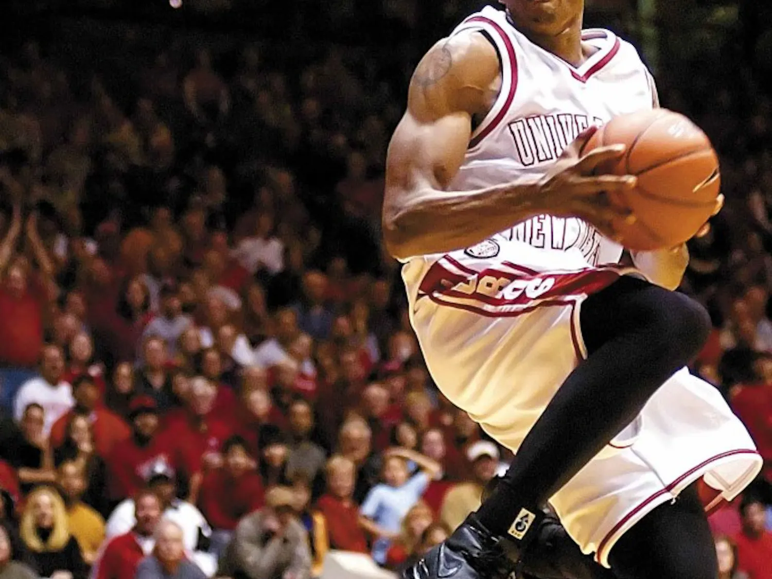 Lobo guard J.R. Giddens goes up for a reverse dunk against Abilene Christian's defense during Friday's 91-54 win at The Pit.