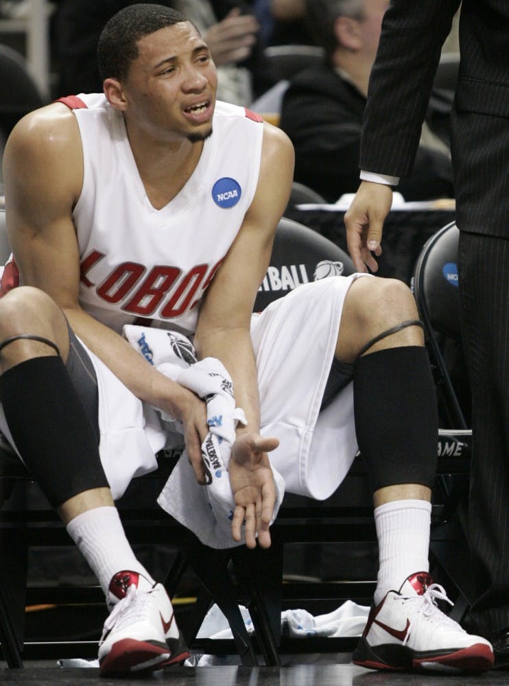 	Darington Hobson clutches is wrist in pain on the Lobo bench after falling on to the hardwood on Thursday in the Lobos’ first-round win over No. 14 Montana. Hobson, who had his wrist wrapped, underwent X-rays but they came back negative. He will play today.