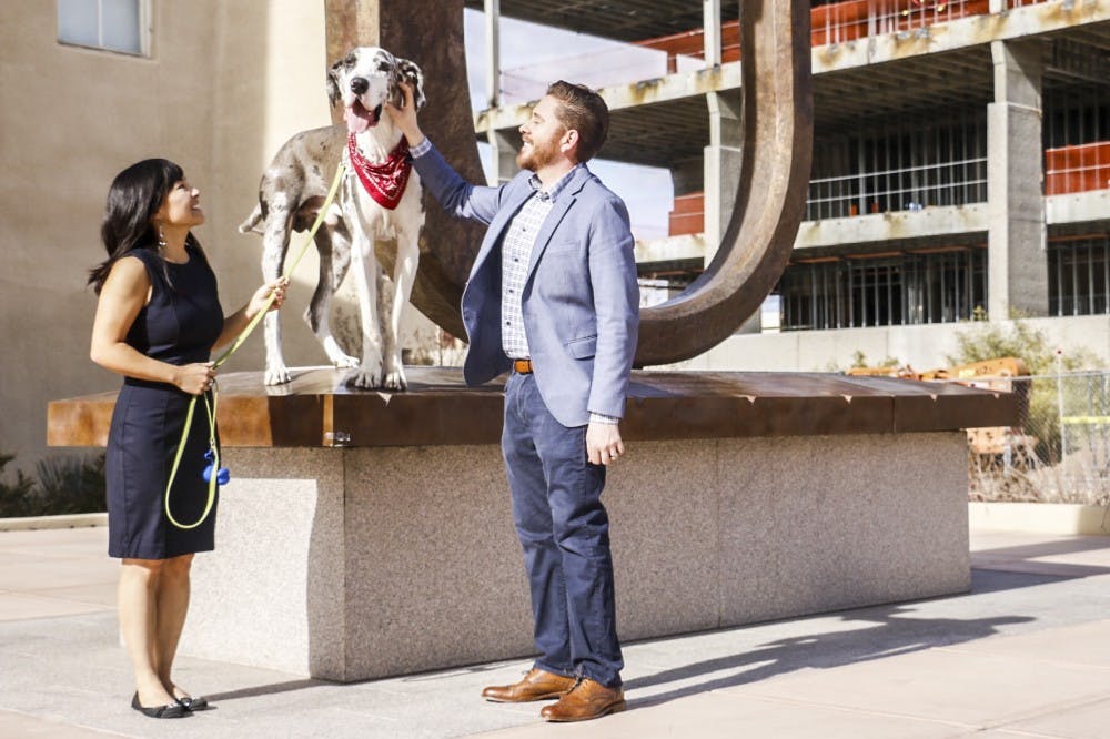 Thanh-Lan Sena, left, with her dog and boyfriend, stands near Hodgins Hall on Sunday, Dec. 11, 2016. Sena was diagnosed with stage four Hodgkin's Lymphoma but beat it and achieved her master’s degree in three semesters.