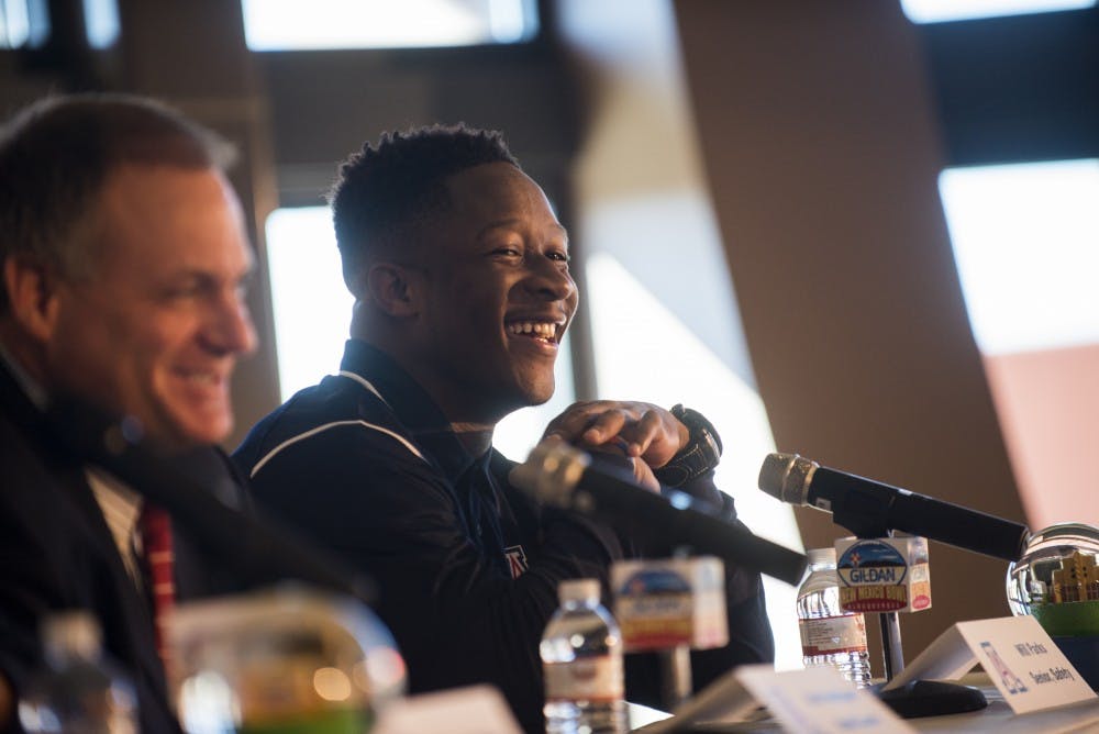 University of Arizona's Will Parks(left) laughs alongside head coach Rich Rodriguez at Friday mornings Gildan New Mexico Bowl luncheon. At the luncheon Rodriguez spoke about his plan to defend the Lobo's triple option. 