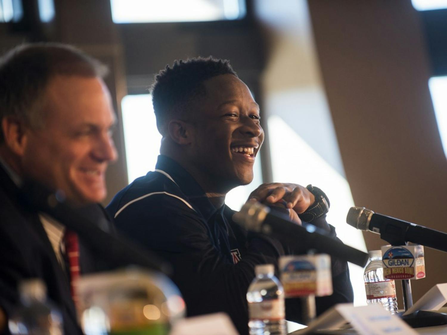 University of Arizona's Will Parks(left) laughs alongside head coach Rich Rodriguez at Friday mornings Gildan New Mexico Bowl luncheon. At the luncheon Rodriguez spoke about his plan to defend the Lobo's triple option. 