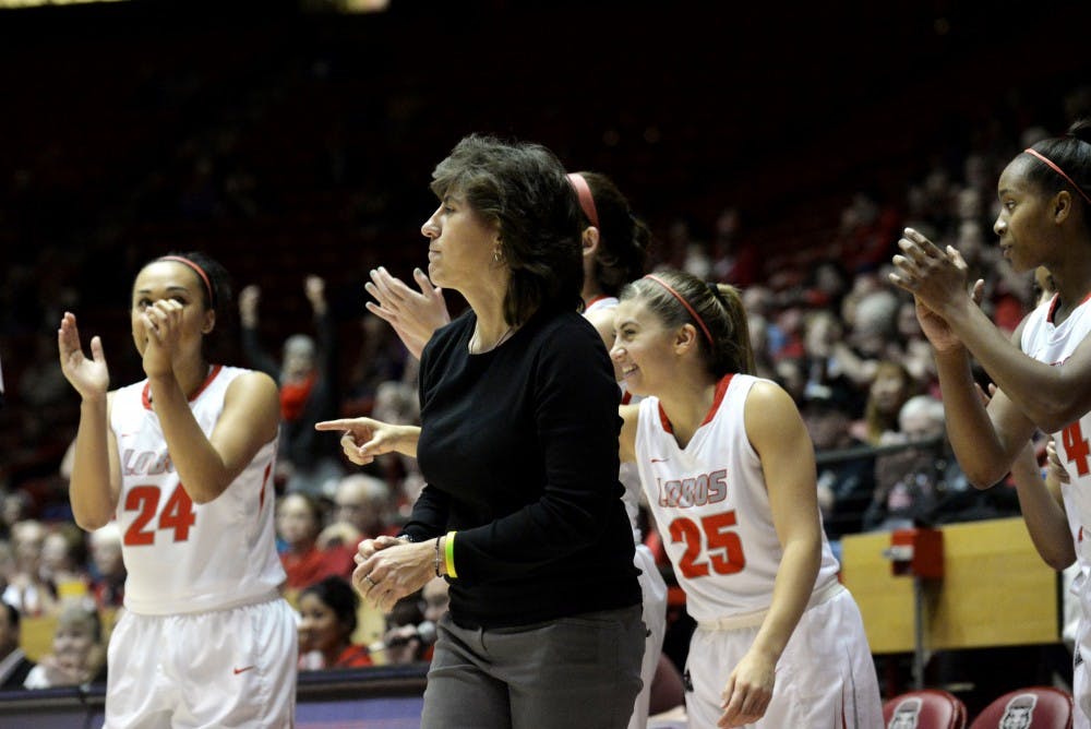 Head womens basketball coach Yvonne Sanchez celebrates with Lobo players during a game against UNLV. Sanchez was relieved of her duties as head coach after serving five seasons in the position.&nbsp;