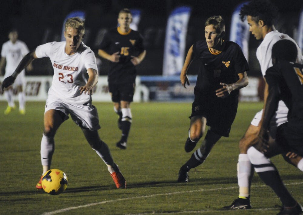 New Mexico forward Sam Gleadle keeps the ball away from West Virginia players at the UNM Soccer Complex on Oct. 1, 2014.