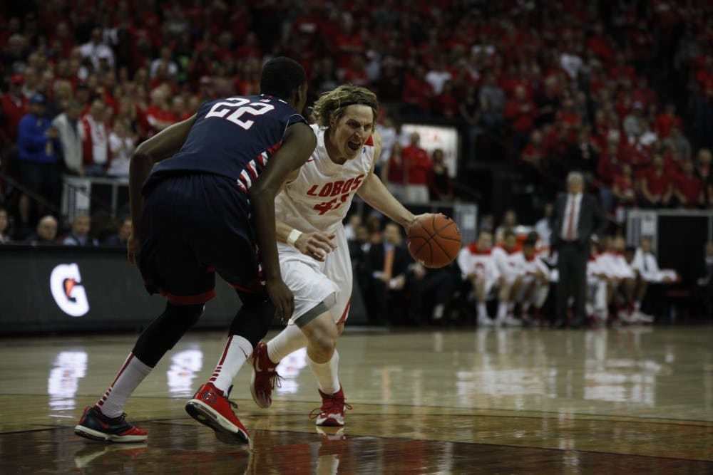 UNM's Cameron Bairstow finds his way around Paul Watson #22 of the Fresno State Bulldogs into the lane during Thursday nights game