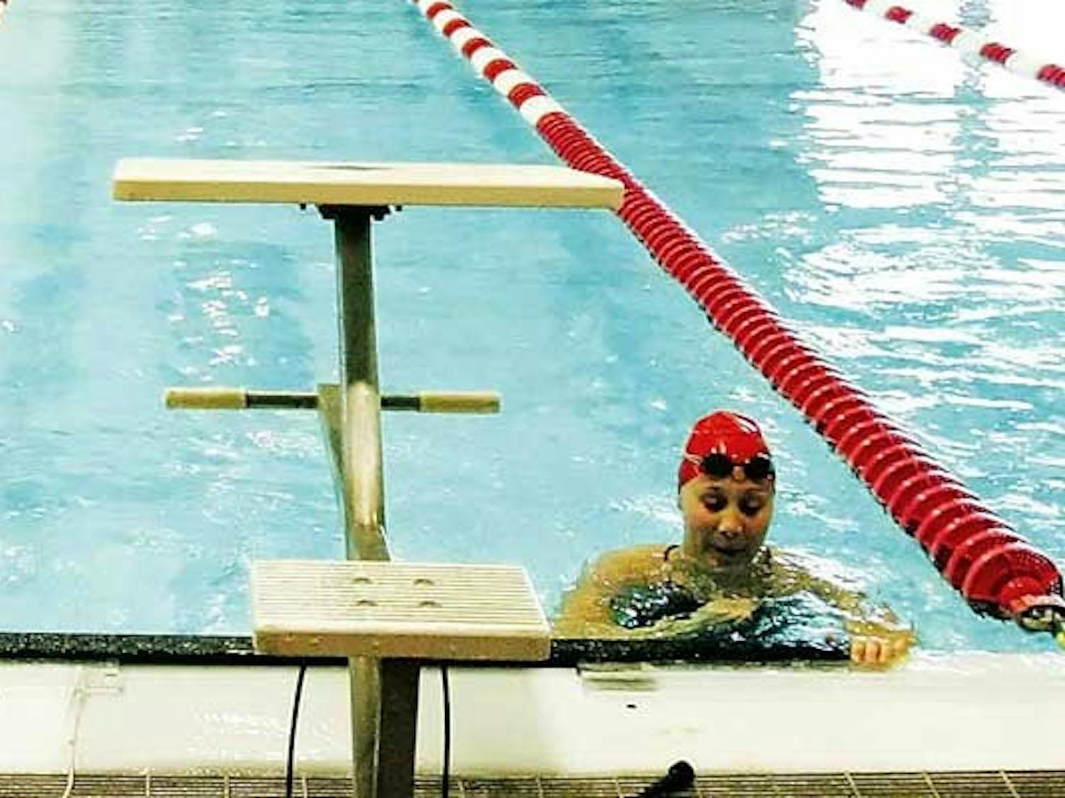Tori Clarridge catches her breath after a swim meet against CSU at Seidler Natatorium on Saturday. Clarridge juggles swimming and nursing school.