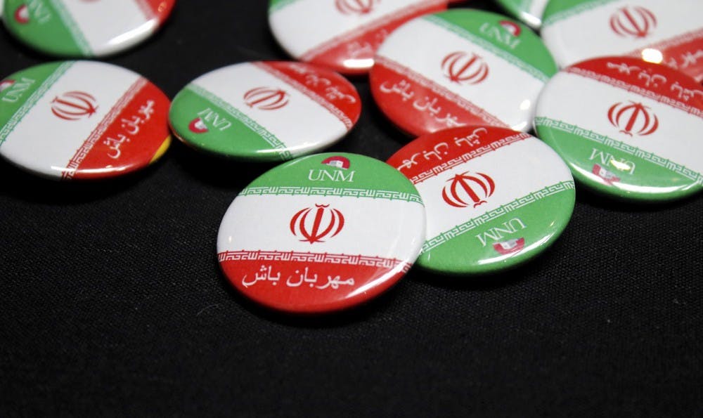 Buttons given out at Thursdays teaching forum include the UNM logo and the Iranian flag.&nbsp;