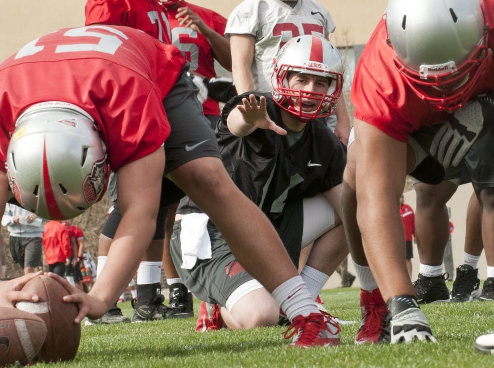 	Junior-college transfer quarterback, Clayton Mitchem takes a snap during the UNM football team’s first spring training session. 