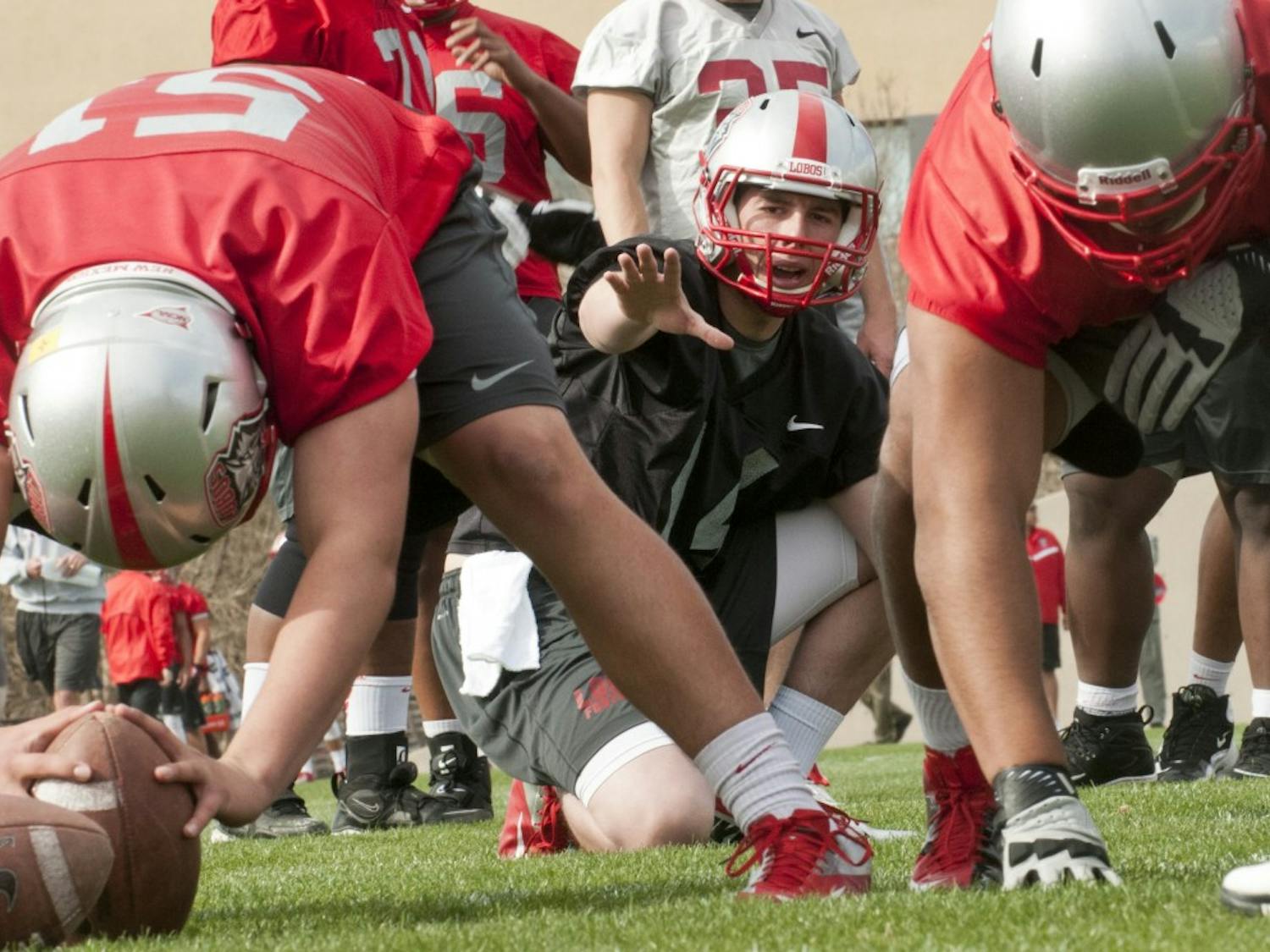 	Junior-college transfer quarterback, Clayton Mitchem takes a snap during the UNM football team’s first spring training session. 