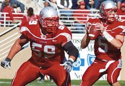 Lobo offensive tackle Robert Turner, left, protects backup quarterback Chris Nelson during a game at University Stadium.