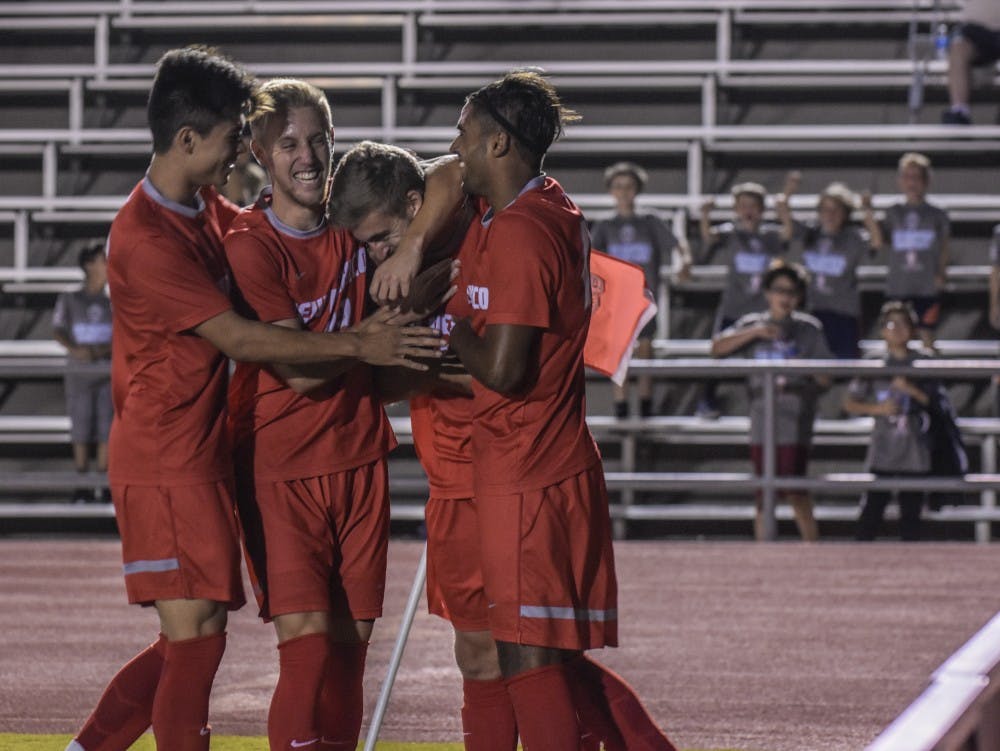 Nick Taylor, left, Sam Gleadle, Antoine Vial, and Alex Vedamanikam celebrate in front of the corner flag after Vial scored the Lobos second goal of the match against California State University Northridge Matadors, Friday, September 8, 2017. The Lobos defeated CSUN 2-1.