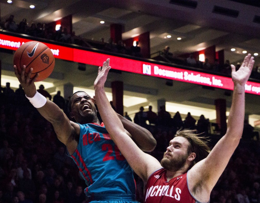 Sophomore Guard/Forward Sam Logwood attempts to score&nbsp;against a&nbsp;Nicholls State player&nbsp;at the WisePIse arena Wednesday night. The Lobos won 75-63 and their next game will be Tuesday Dec. 1.&nbsp;