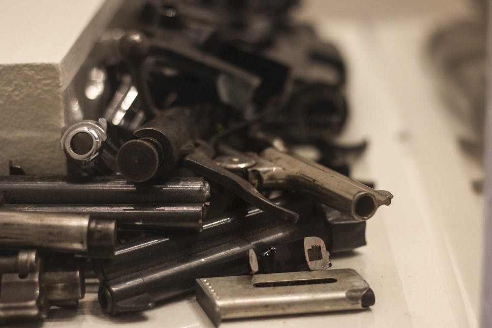 Gun pieces lay in a pile at the Maxwell Museum at the Gun Violence Exhibit.