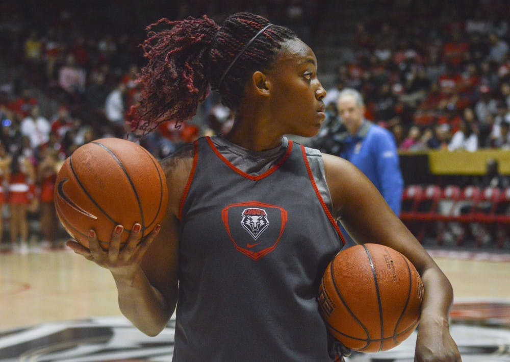 Former Lobo redshirt senior center Ebony Walker holds two basketballs while waiting to start a passing drill during Lobo Howl at the Pit on Oct. 17. Women’s basketball head coach Yvonne Sanchez announced that Walker has been released from the team following her arrest for a domestic dispute earlier this month.