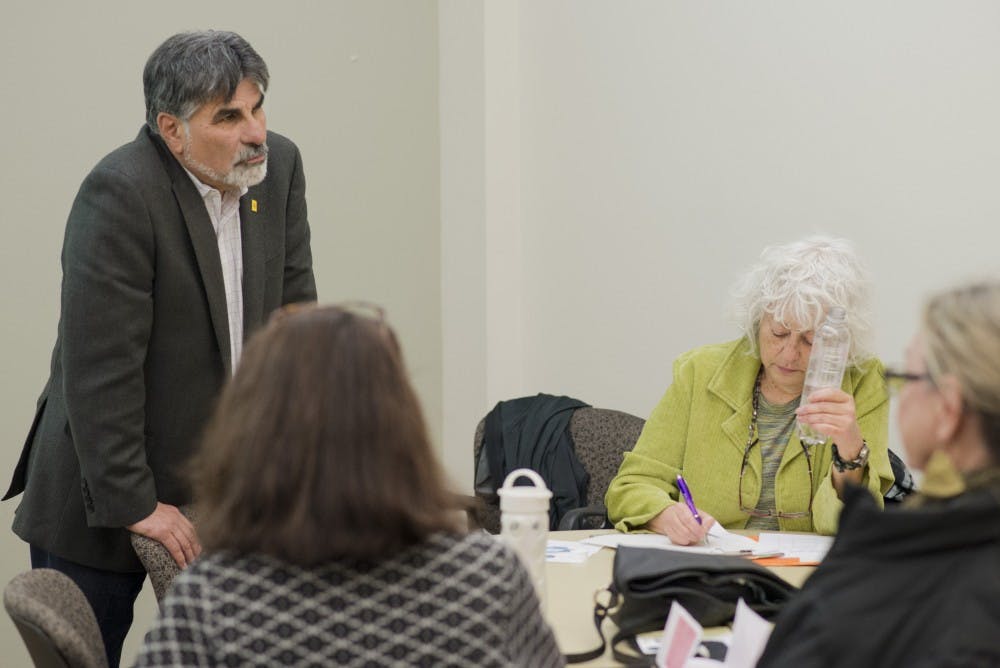 Former State Rep. Rick Miera, left, discusses New Mexicos legislative process during a Thursday workshop sponsored the Peace and Justice Studies Program. The event focused around bills currently being voted on in the ongoing New Mexico legislative session.