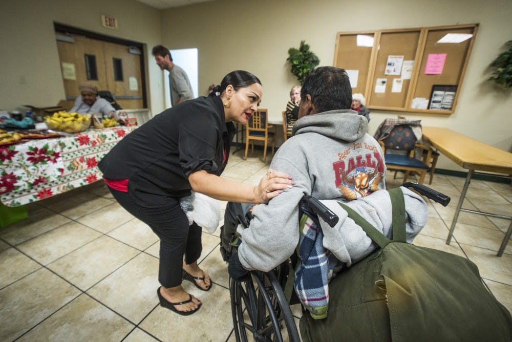 Jennie Noriega speaks to a homeless man about getting him back home to Taos on Sunday, Dec. 11, 2016. Noriega is a pastor at ABQ Central Inner City Ministries, where she works to help people in her former community.
