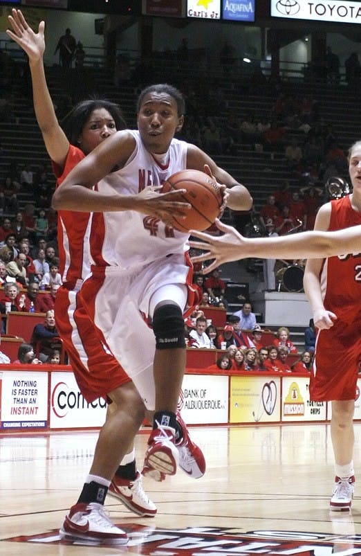 UNM guard Brandi Kimble drives past UNLV forward Latoya Hunt during Saturday's 94-64 win at The Pit. 