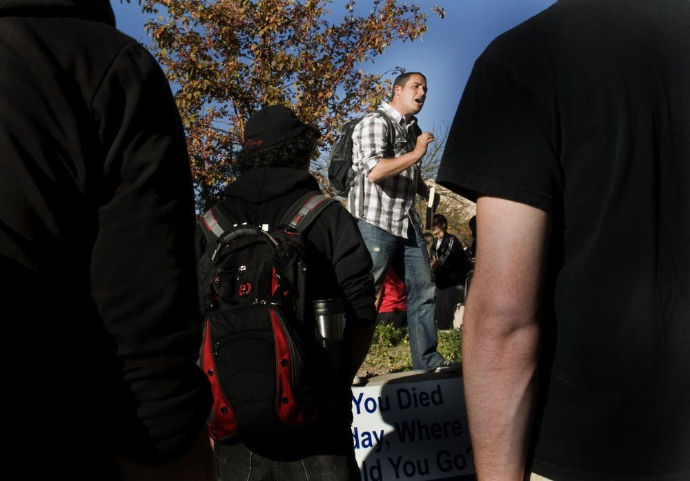 	Ken Fleck preaches to a crowd of students outside of the SUB on Monday. Fleck is one of several Christian advocates from across the country who came to talk to UNM students.
