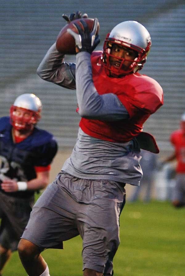 Lobo wide receiver Travis Brown catches a pass during practice Tuesday at University Stadium. 