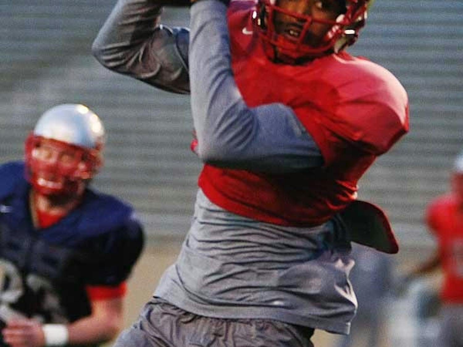 Lobo wide receiver Travis Brown catches a pass during practice Tuesday at University Stadium.