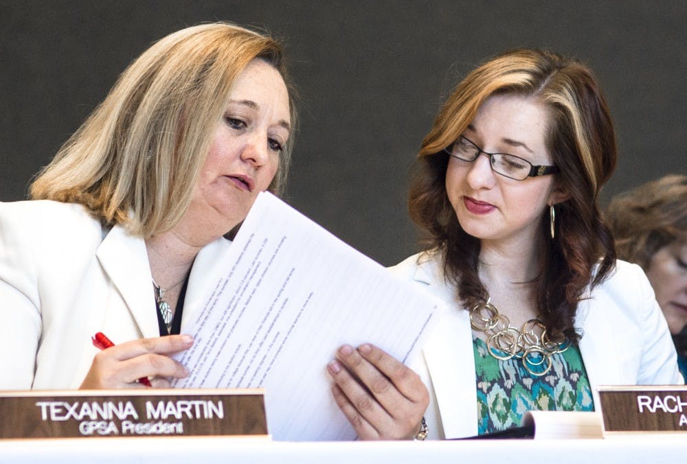 	Graduate &amp; Professional Student Association President Texanna Martin, left, and Associated Students of the University of New Mexico President Rachel Williams read the agenda at the Board of Regents meeting Friday. It was Martin and Williams’ first Regents meeting as presidents of the student governments.