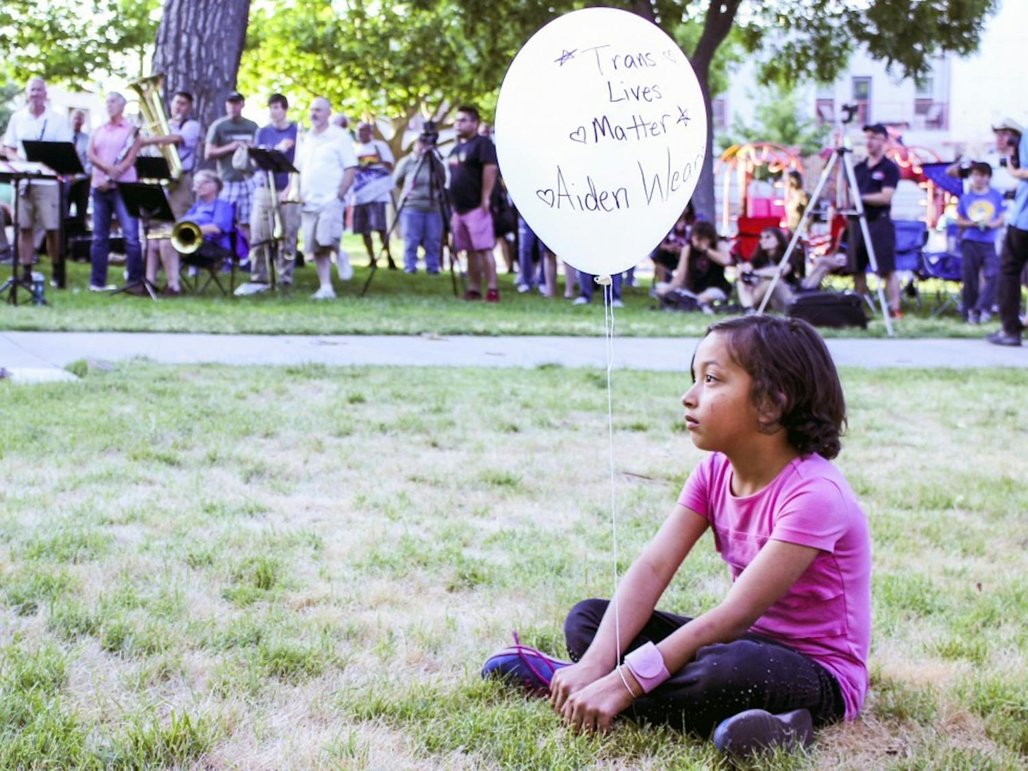 Aiden Wear, 8 years old, holds a balloon in support of the Trans Lives Matter Movement and as a tribute to the 49 lives lost last year in the Orlando night club shooting. The Candlelight Vigil was held at Morningside Park on June 8, 2017.