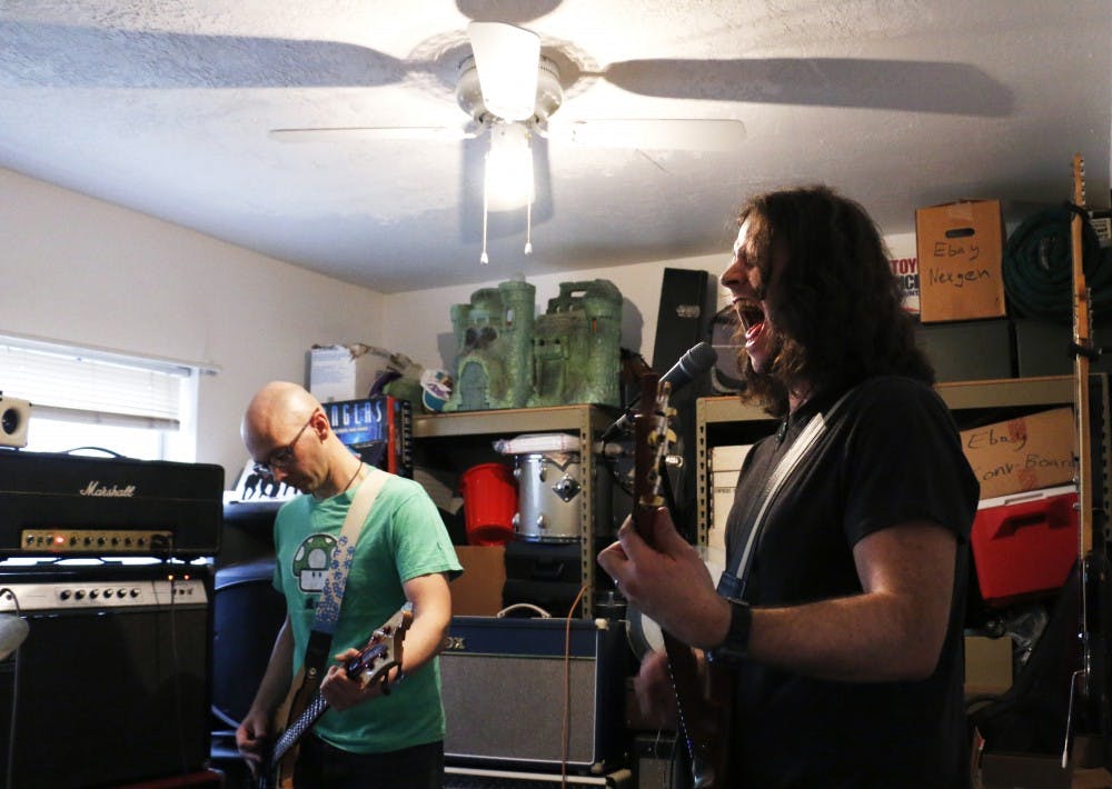 Adam Saidel (right) and Justin Curtner play guitar alongside drummer Chirs Moffatt at Curtner's house Monday evening. The musicians make up the band Sugarmotor, a local Albuquerque rock band.&nbsp;