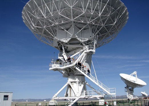 Students from Greg Taylor's radio astronomy class climb a radio antenna at the Very Large Array, part of the Long Wavelength Array project, in Socorro on Feb. 21. The antennas will help scientists, some trained at UNM, learn more about weather in space.